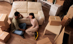 diverse-husband-wife-sitting-apartment-floor-enjoying-relocation-thinking-about-living-room-decorations-after-moving-togteher-rented-family-property-top-view