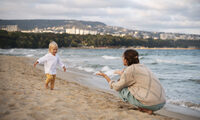 parent-with-baby-beach-sunset