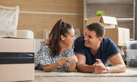 couple-showing-keys-new-house-moving-day